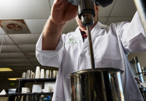 Chemist operating mixing machine