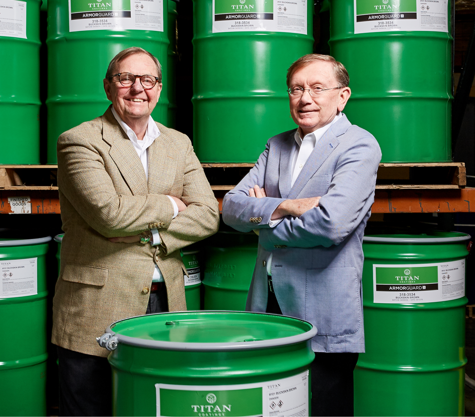 Titan partners posing for camera in front of their new paint drums.